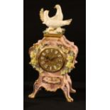 A Baroque style ceramic clock, Mediflor, Valencia, applied with flowers on a pink ground, crested