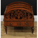 A Victorian walnut three section Canterbury, shaped divisions pierced with stylised leaves, drawer