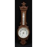 A late Victorian/Edwardian carved oak aneroid barometer, 87.5cm high, 26cm wide, c.1900