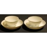 A pair of 18th century Chinese tea bowls and saucers