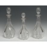 A pair of clear glass baluster decanters and stoppers, 33.5cm high; another, smaller (3)