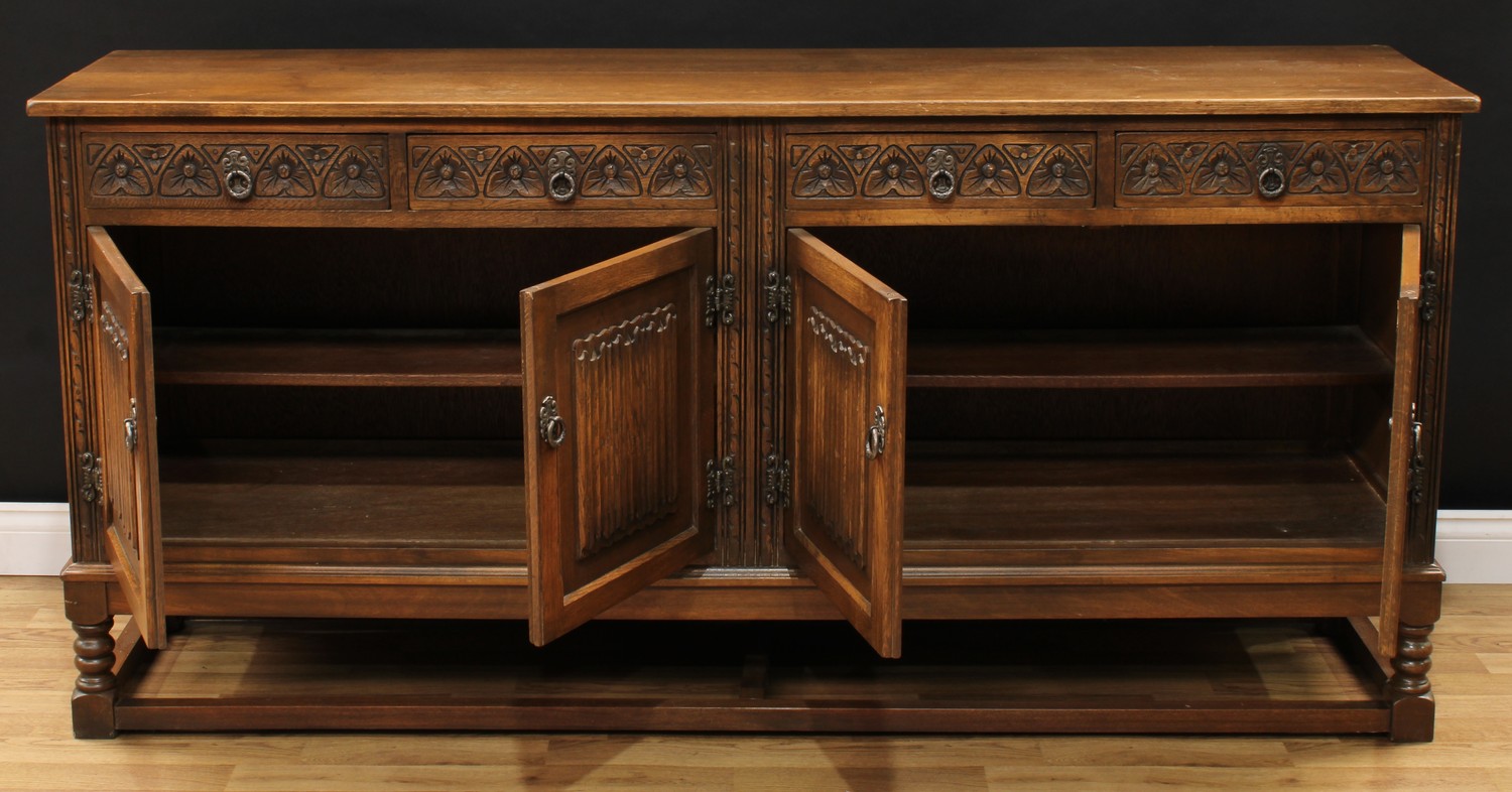 An Old Charm oak low dresser, rectangular top above four frieze drawers and two pairs of linenfold - Image 2 of 4