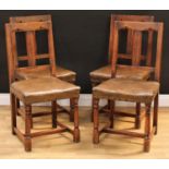 A set of four early 20th century oak dining chairs, 91cm high, 46cm wide, the seat 38cm deep