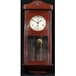 A Westminster chime wall clock, Arabic numerals, twin winding holes, pendulum and key, 80cm