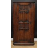 An oak hall robe, shallow cornice above a single door, the panels carved and applied with flowers,