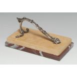 A silvered metal and marble rectangular desk weight, the scroll handle cast with a mask and