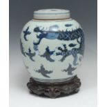 A Chinese ovoid ginger jar and cover, painted in underglaze blue with a ferocious dragon and