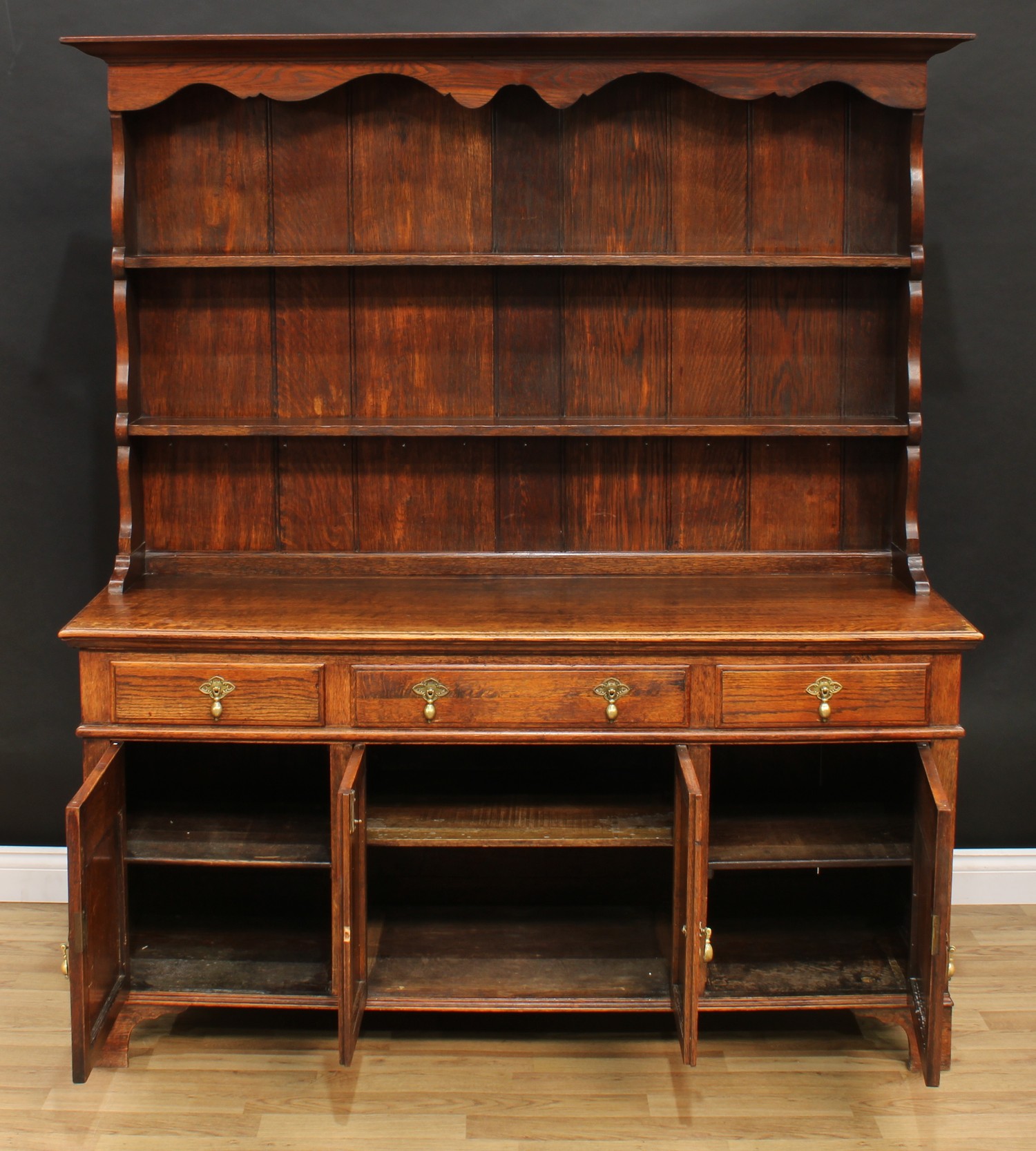 An oak dresser, outswept cornice above a pair of plate racks, the projecting base with three - Image 2 of 4