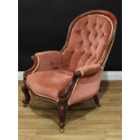 A Victorian mahogany spoon back drawing room chair, deep-buttoned upholstery, the outswept arms