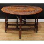 An 18th century oak gateleg table, near-circular top with fall leaves, the centre carved with