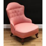 A Victorian mahogany nursing chair, shaped back, deep-buttoned stuffed over upholstery, turned legs,