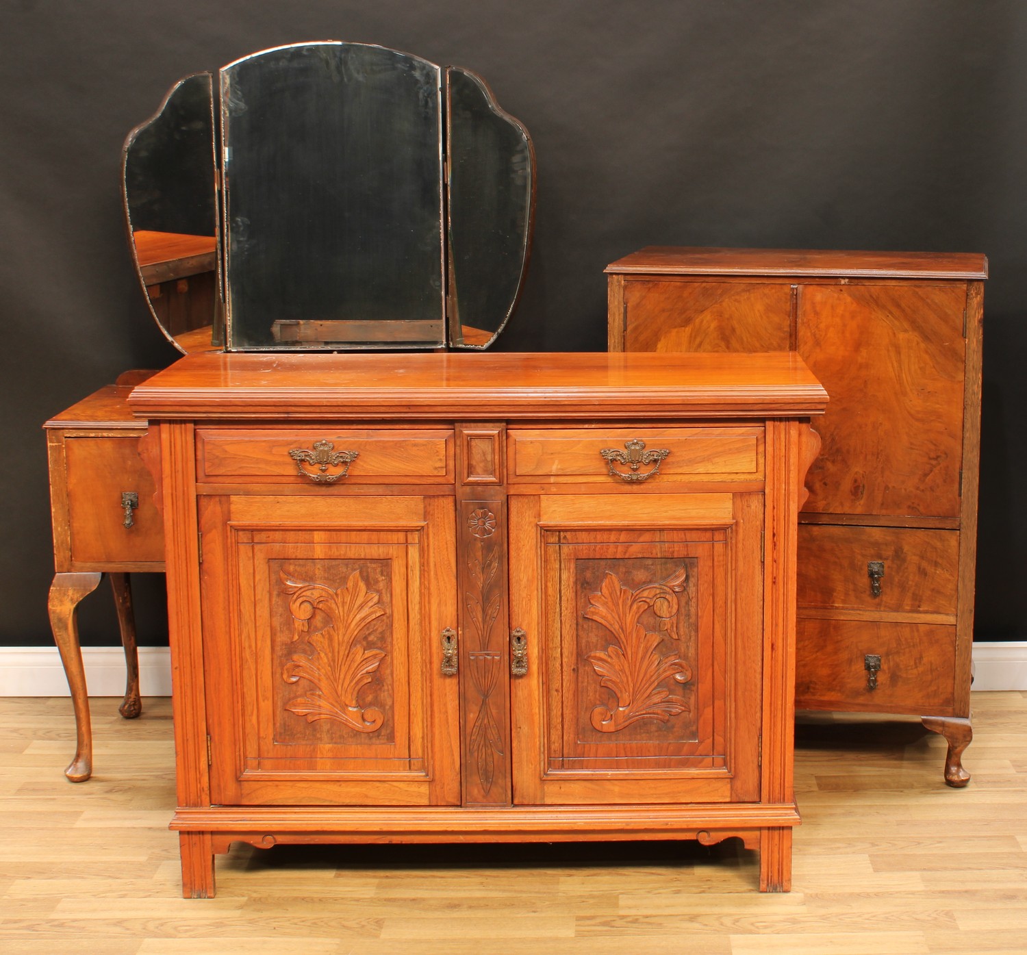 A two piece walnut bedroom suite, comprising dressing table, 154.5cm high, 108cm wide, 50cm deep and