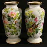 A pair of Limoges tapering cylindrical shoulder vases, painted with birds perched amongst leafy pink
