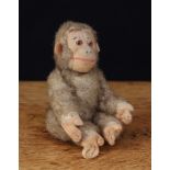 A 1930's novelty brown mohair and cream felt miniature straw filled jointed Monkey, cream felt