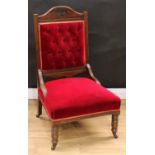 A Victorian mahogany nursing chair, red velvet upholstery, 105.5cm high, 61cm wide, 53cm deep