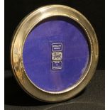 An Elizabeth II silver easel photograph frame, the aperture 11cm diam, Birmingham 1991