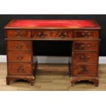 A George III style twin pedestal writing desk, chamfered rectangular top with inset writing