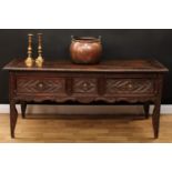 An 18th century oak serving table, oversailing rectangular top above three frieze drawers, carved