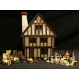 A Tudor style doll's house, fitted with an assortment of resin furniture, accessories and dolls,