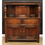 A 17th century style oak duodarn or court cupboard, rectangular top above a nulled frieze and a