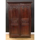 An 18th century oak armoire, outswept moulded cornice above a pair of raised and fielded panel
