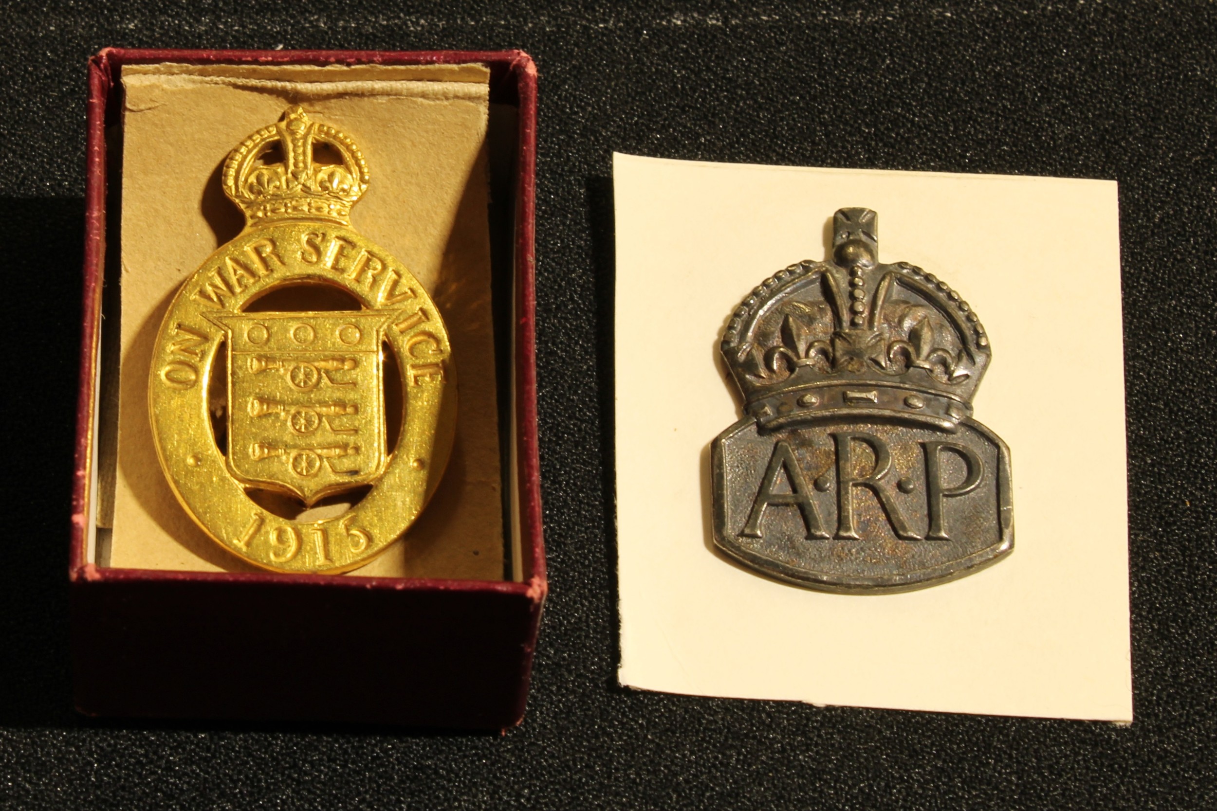An On War service badge, 1915, original box; a hallmarked silver ARP badge, (2).
