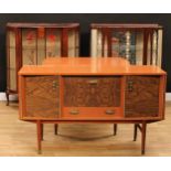 A retro mid-20th century drawer-leaf dining table; a conforming sideboard; a display cabinet;