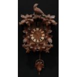 A Black Forest cuckoo clock, crested by a bird of prey, 44cm high