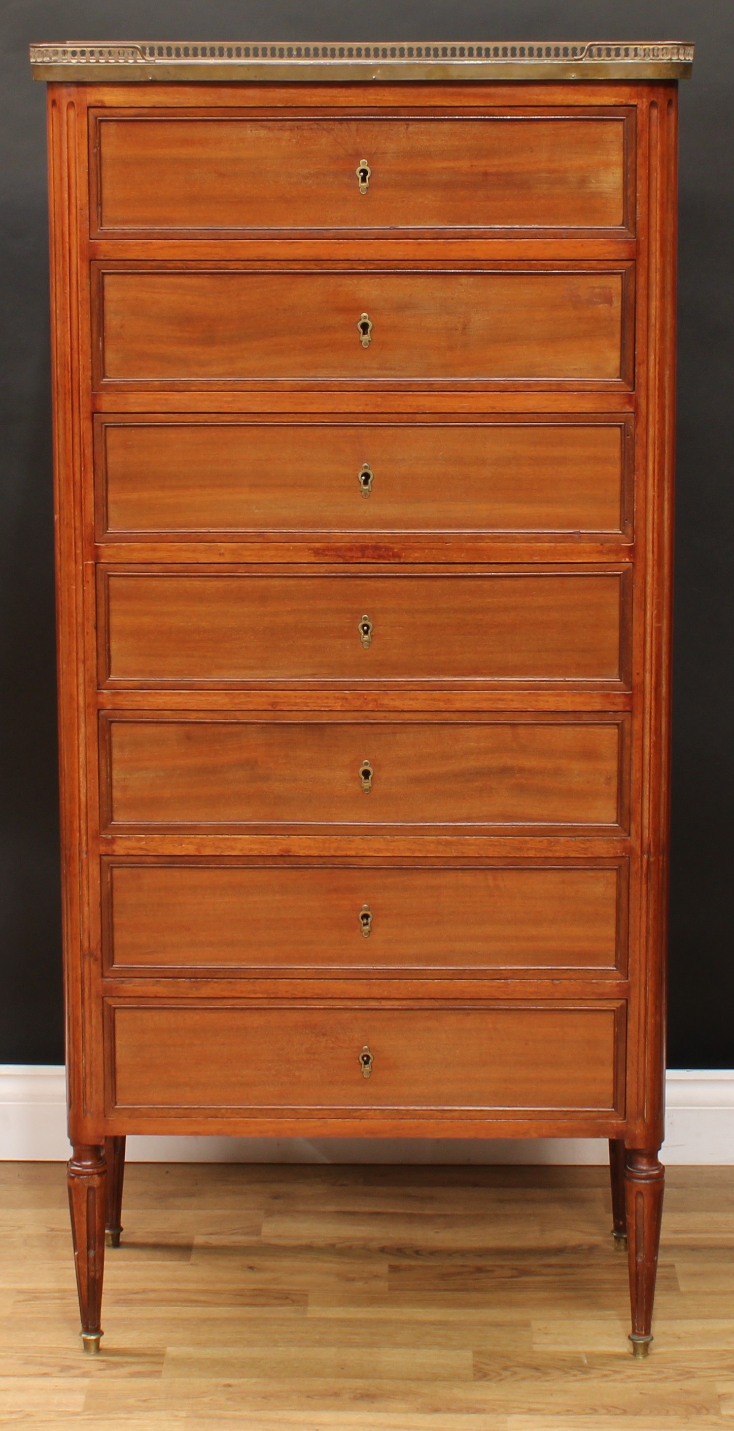 A late 19th century French semainier chest, rectangular top with pierced brass gallery above seven