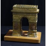 A cast desk model, of L'Arc de Triomphe, 18.5cm high over stand