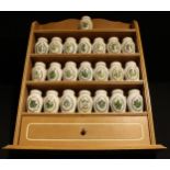 A set of twenty two Franklin Mint spice jars on kitchen rack, designed by Gloria Vanderbilt,