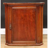 A 19th century mahogany splay front corner cabinet, moulded cornice above a rectangular panel door