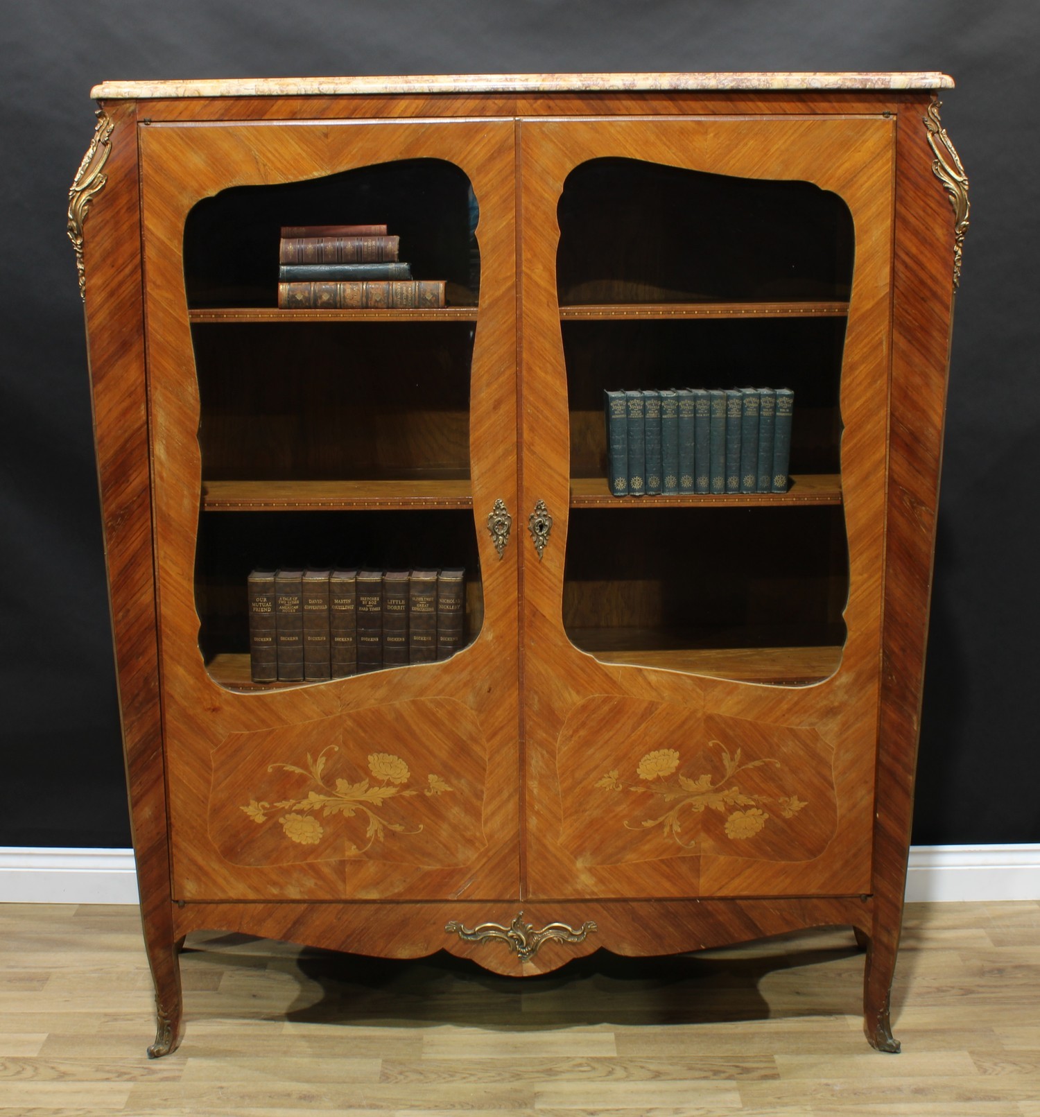 A Louis XV style gilt metal mounted kingwood and marquetry bookcase, marble top above a pair of