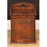 Tobacciana - an early 20th century oak smoker's companion cabinet, 39.5cm high, 28.5cm wide, 20.