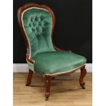 A Victorian mahogany nursing chair, trefid spoon back, serpentine seat, cabriole forelegs, 94.5cm