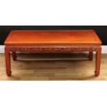 A Chinese hardwood low tea table, rectangular panelled top above a shaped frieze pierced and