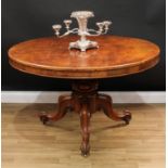 A Victorian walnut centre table, circular tilting top, turned column carved with stylised egg-and-