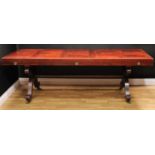 A French Empire mahogany rectangular dining table, the panel top with deep frieze applied with brass