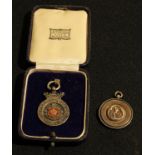 Leicester FA silver and enamel fob, 1910/11; a Notts football fob (2)