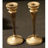 A pair of silver dressing table candlesticks, Chester 1931, hollow filled, 17.5cm