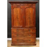 A Victorian mahogany linen press, concave moulded cornice above a pair of arched panel doors