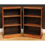 A pair of mahogany open bookcases, of small proportions, each with a moulded rectangular top above