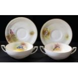 A pair of Royal Worcester hand painted soup dishes on stands, Game Bird pattern, including Pheasant,