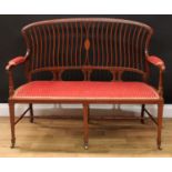 An Edwardian mahogany and marquetry sofa, shaped cresting rail inlaid with an oval batwing patera