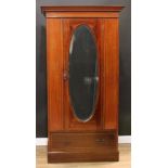 An Edwardian mahogany wardrobe, outswept cornice with faux-dentil parquetry apron above an oval