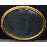 A 19th century oval gilt mirror
