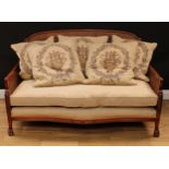 A contemporary bergere sofa, canework back and sides, paw forefeet, 86.5cm high, 143cm wide, the