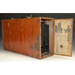 An early 20th century magic lantern, by Newton & Co, London, 46cm long, mahogany case with paper