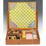 An Edwardian mahogany games compendium, hinged cover enclosing an arrangement of chess and other
