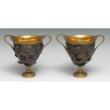 A pair of 19th century gilt and brown patinated krater vases, facsimiles after the antique, by